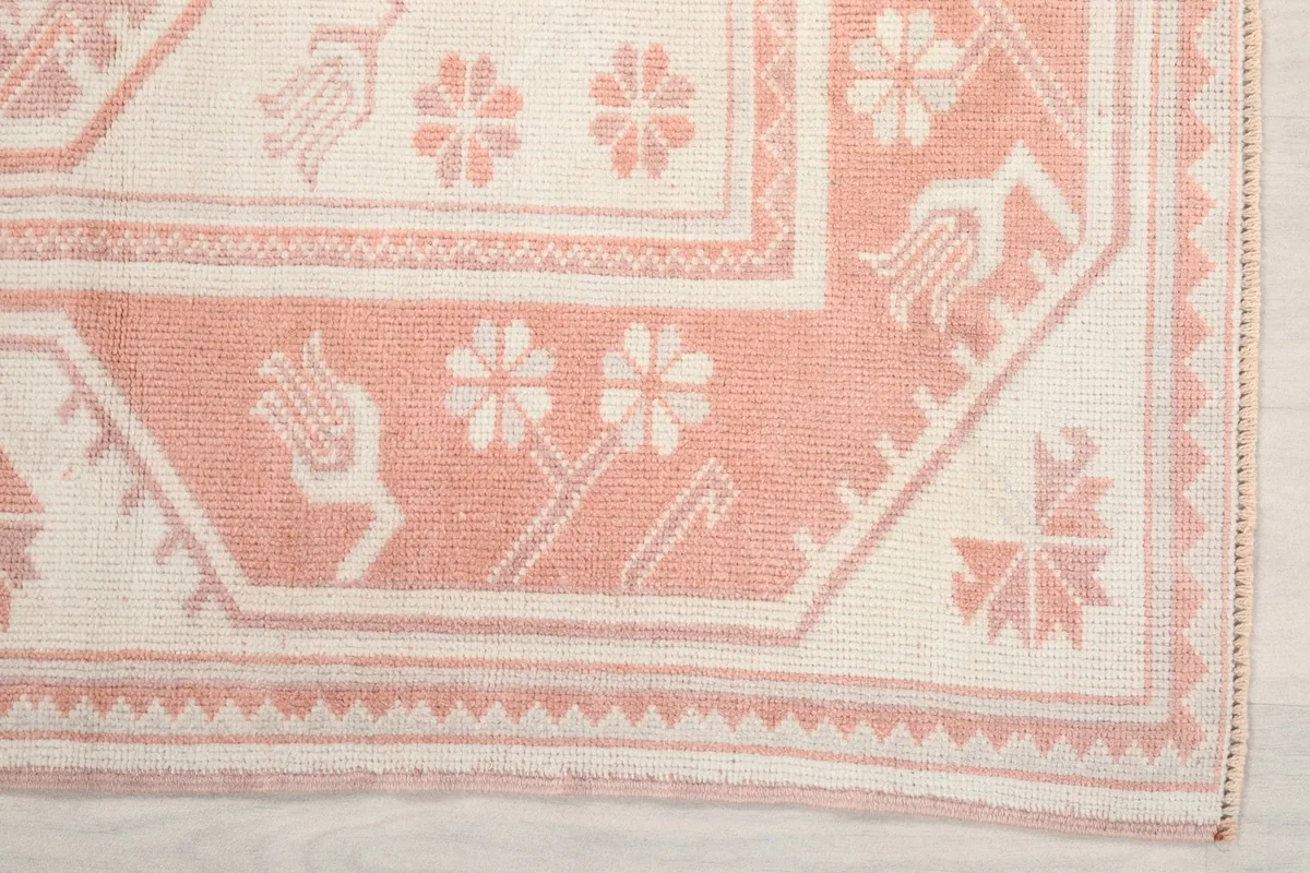 Detailed view of the border design with stylized floral and tribal motifs