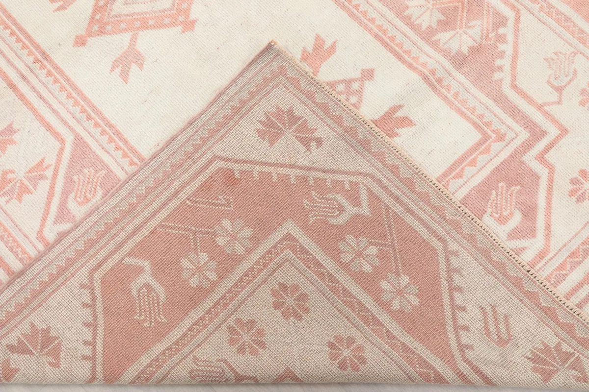 Folded corner of the rug, revealing the reverse side of the hand-knotted weave
