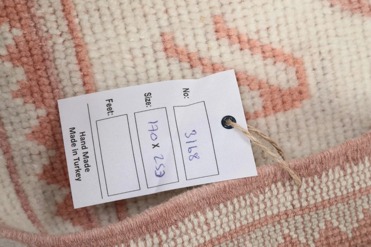Product tag displaying the rug's dimensions and origin as hand-made in Turkey