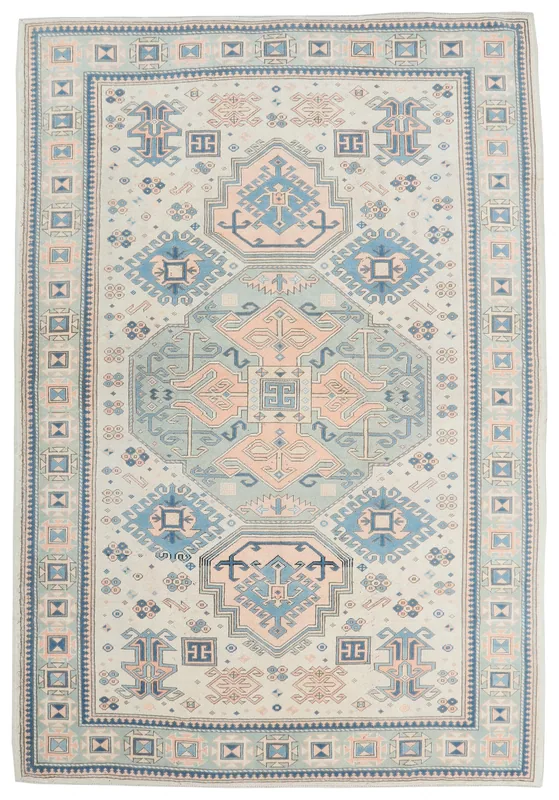 Full top view of the 6'9" x 9'11" vintage Anatolian rug with ivory, blue, and rose colors.