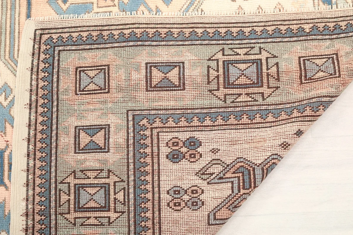 Close-up of the back of the hand-knotted rug, revealing the quality of the craftsmanship.