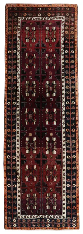 Full top view of the vintage Anatolian runner rug with red field and navy border