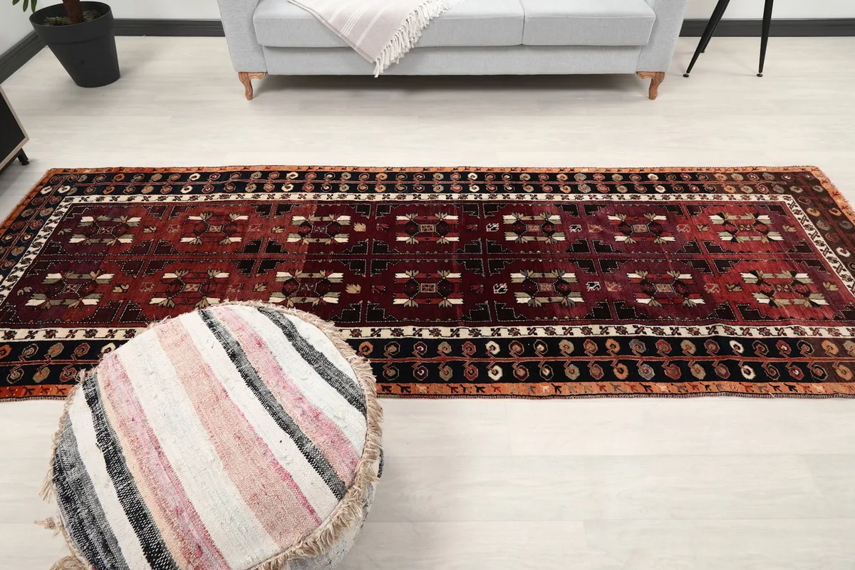 Long view of the runner rug placed in a room, showcasing its full length and design