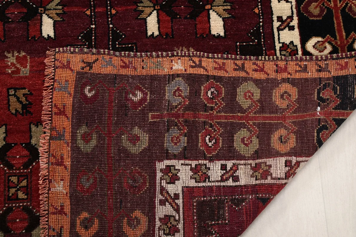 Close-up of the back of the rug, showing the hand-knotted construction and fringe