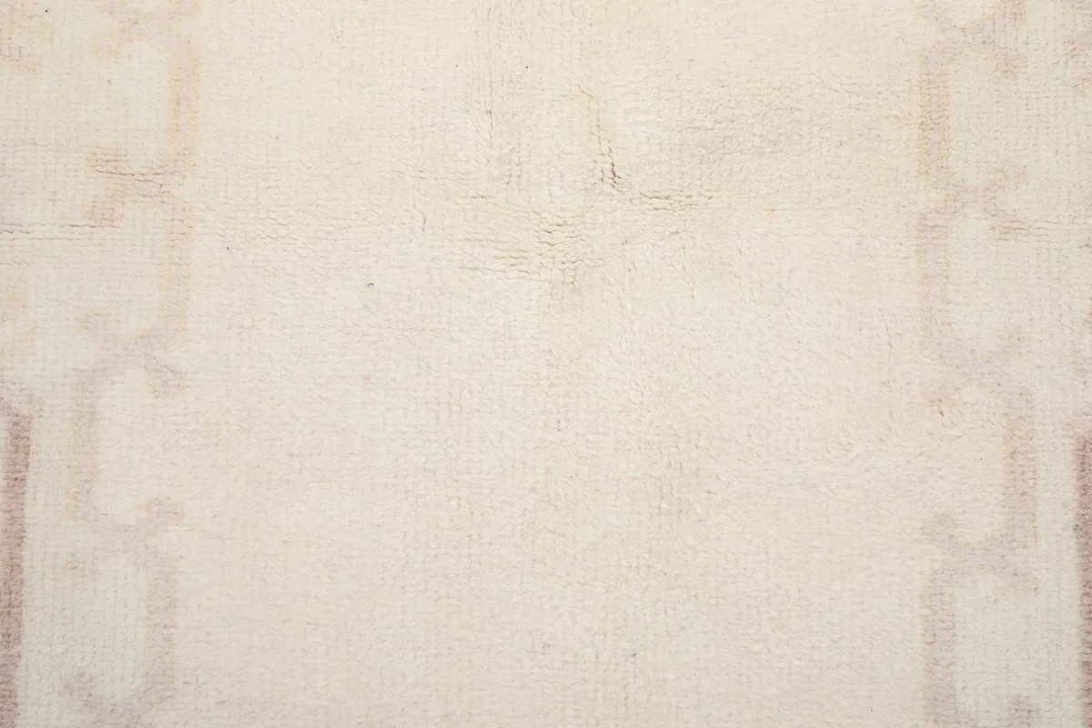 Close-up of the low wool pile texture and hand-knotted weave of the rug