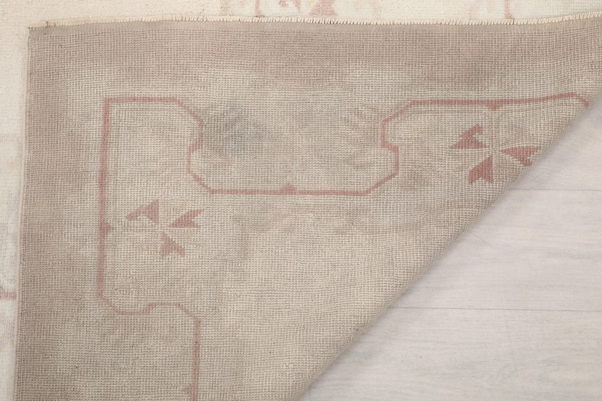 Close-up of the rug's back, showing the tight knotting and foundation material