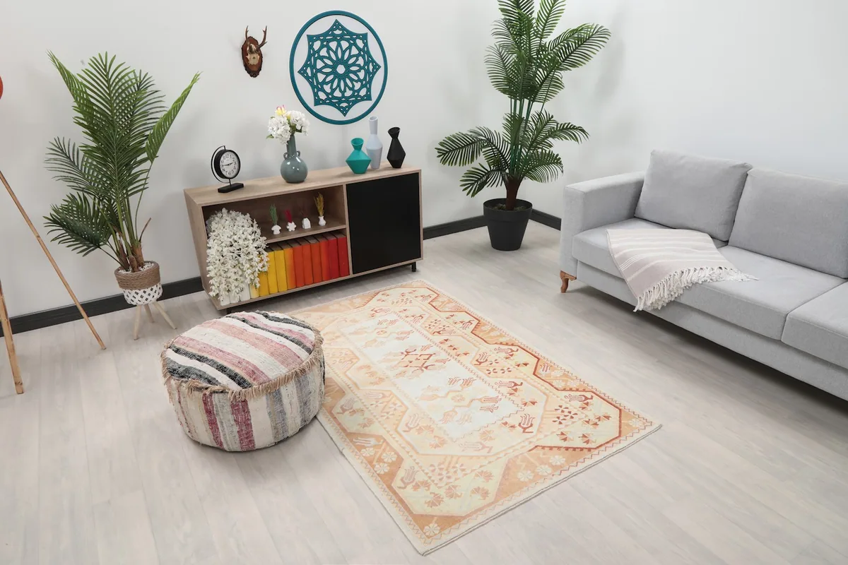 Wide angle view of the ivory and orange vintage Anatolian rug in a modern living room
