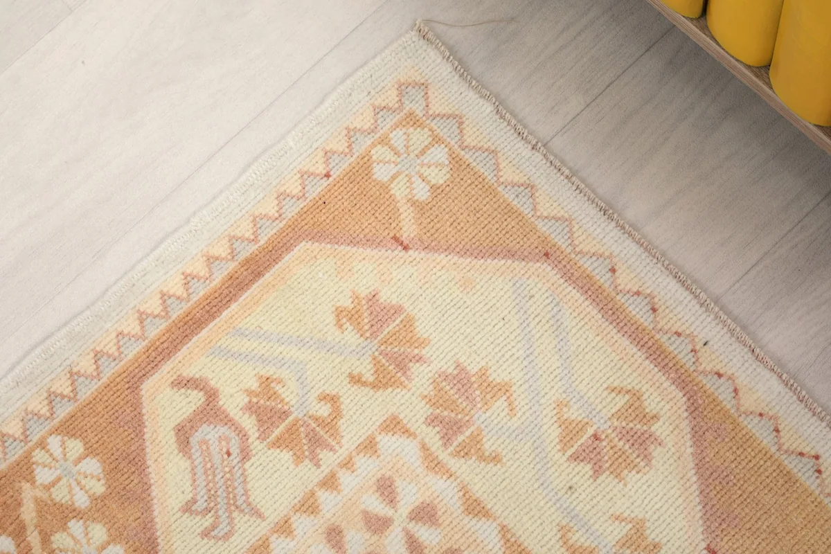 Close-up of a corner of the rug, highlighting the intricate geometric border design