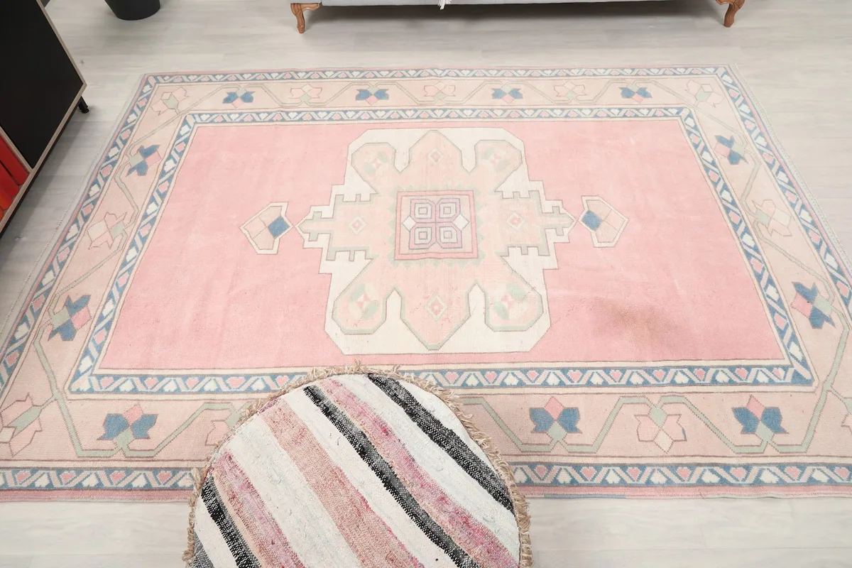 Full overhead view of the pink beige rug, capturing its overall design and proportions.