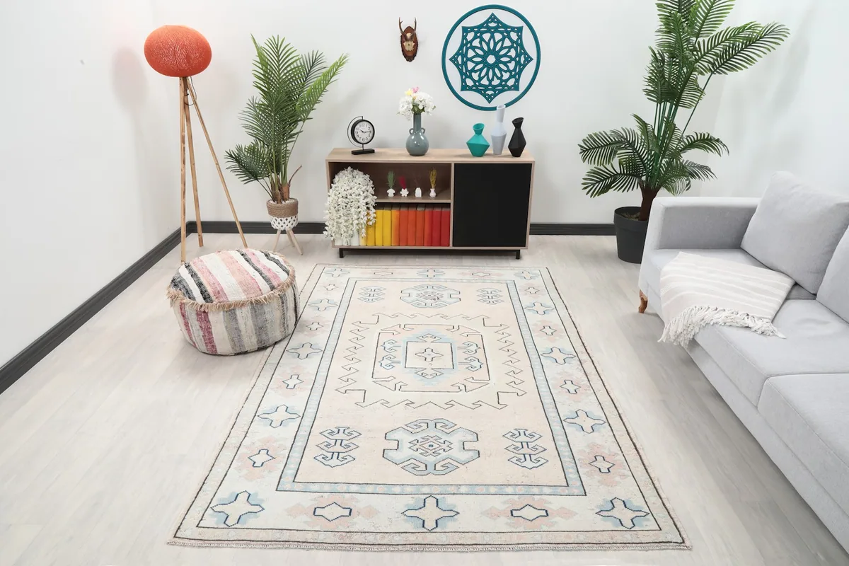 Ivory and blue vintage rug displayed in a bright living room setting with modern furniture