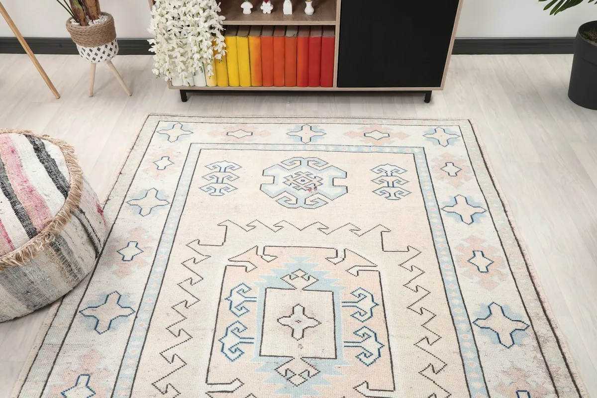 View of the ivory and blue rug from a different angle in the living room setup