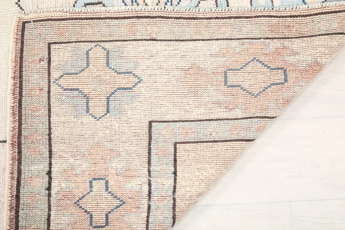 View of the rug's back, showcasing the hand-knotted construction and wool material