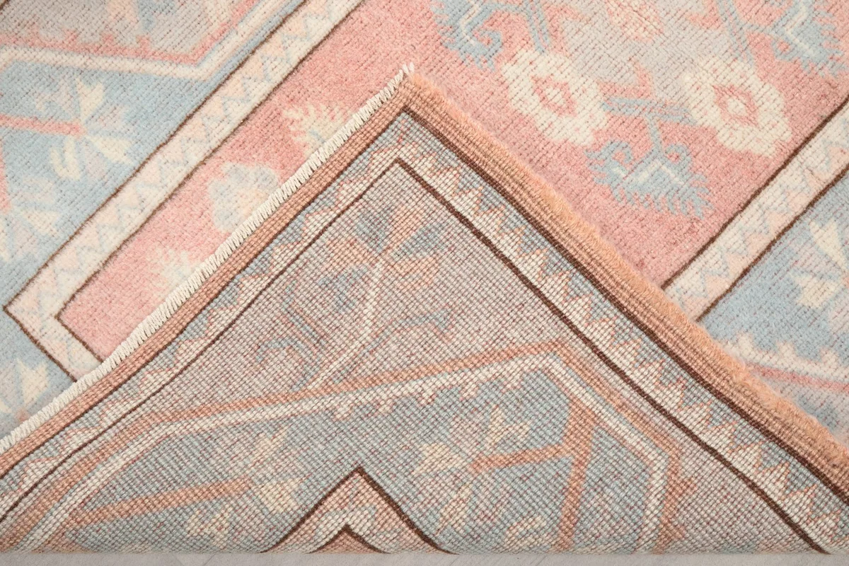 Close-up of the back of the hand-knotted rug, revealing its construction