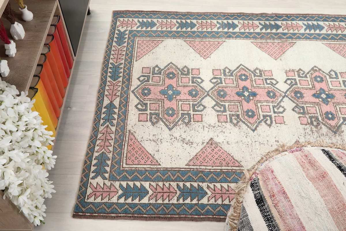 Angled view of the rug's surface, capturing the texture and colors of the vintage wool