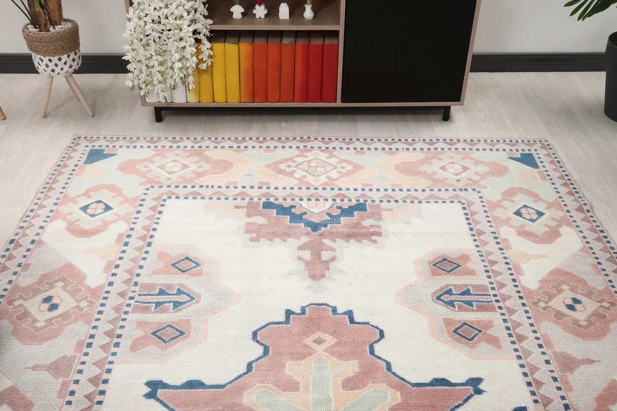 Overhead angled view of the Ivory Rose Geometric Anatolian Rug, showing part of the room and rug's patterns