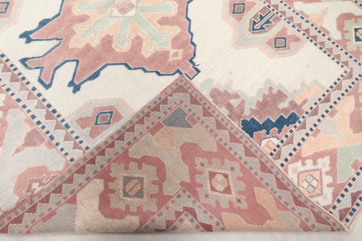 Folded corner of the Ivory Rose Geometric Anatolian Rug, revealing the reverse side and knotting