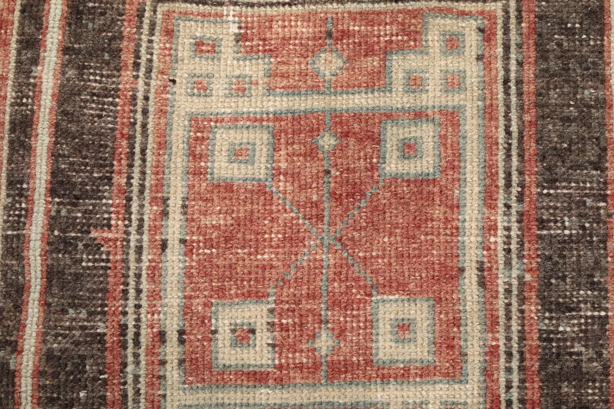 Close-up showing the texture and design within a geometric medallion, highlighting colors and weave.