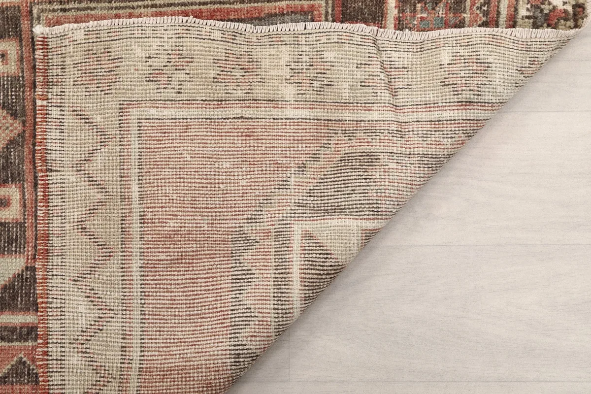 Another view of the rug's reverse side, showing the knotting and foundation.
