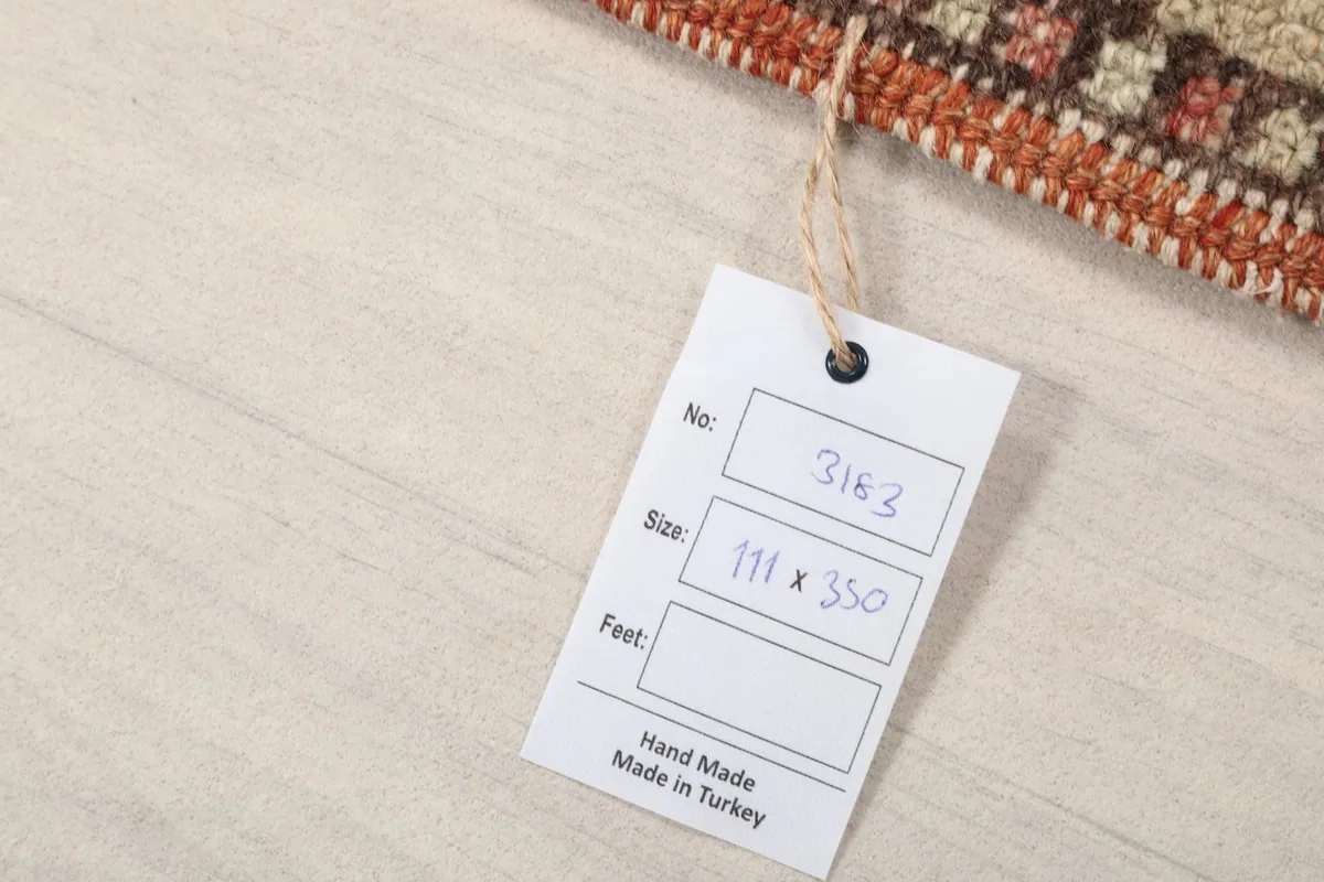 Close-up of the product tag indicating the rug's dimensions and origin from Turkey.