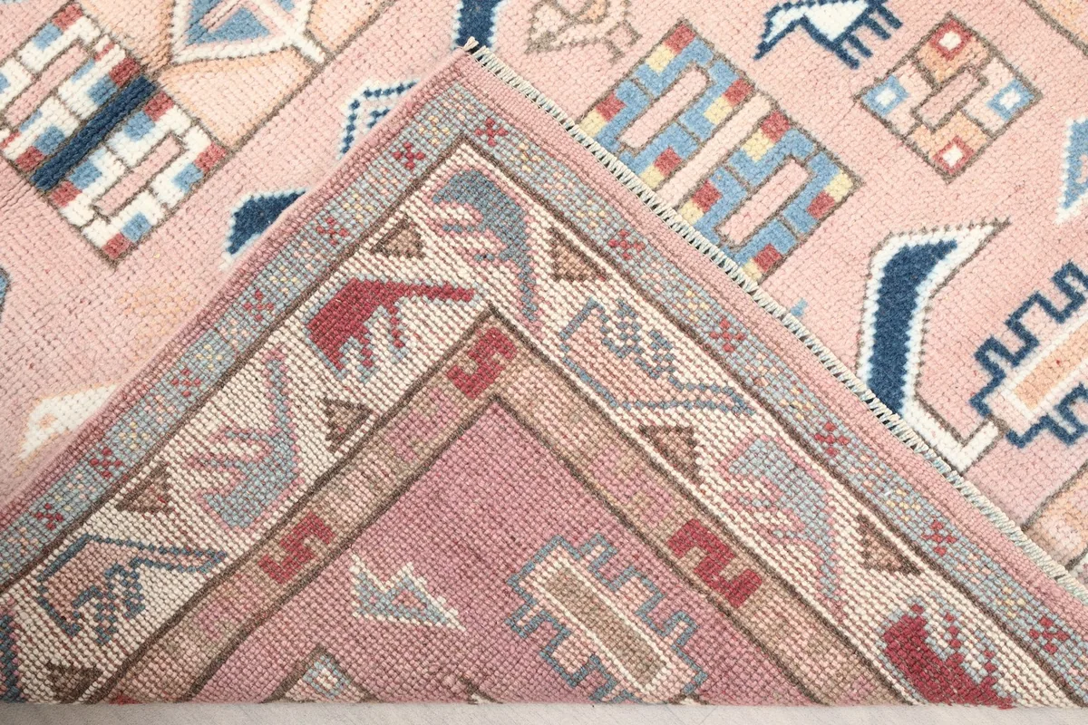 View of the back of the hand-knotted wool rug, showing the intricate knotting and foundation.