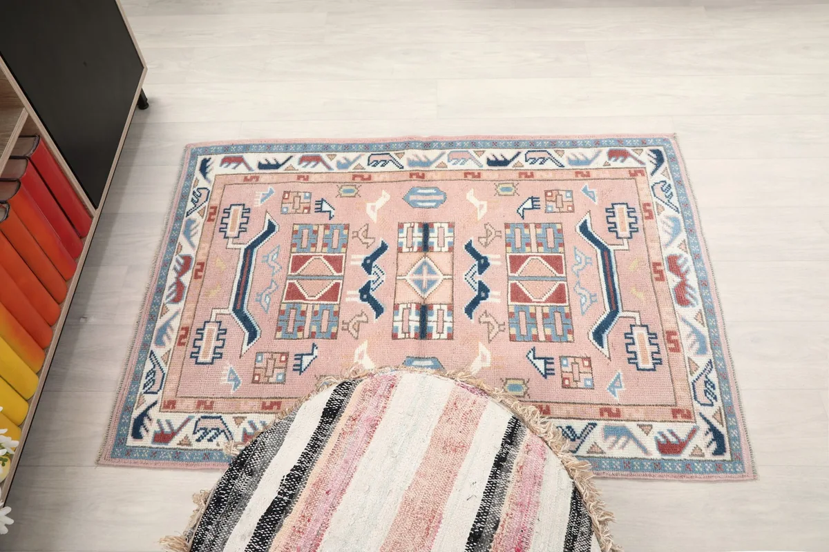 Direct overhead shot of the rose rug, showcasing its full design and rectangular shape.