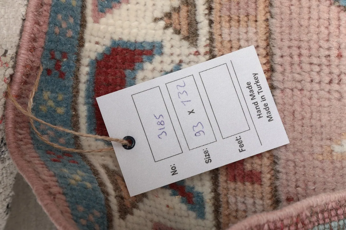 Product tag attached to the rug, displaying its size in both feet and centimeters.