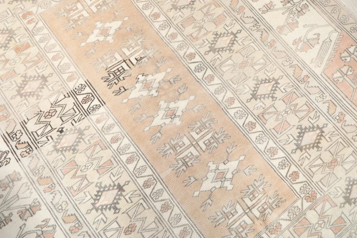 Angled view highlighting the geometric patterns and color variations across the rug