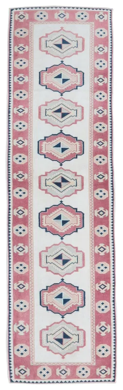 Full overhead view of the 2'5" x 9'4" vintage Anatolian runner rug with rose, navy, and cream geometric patterns.