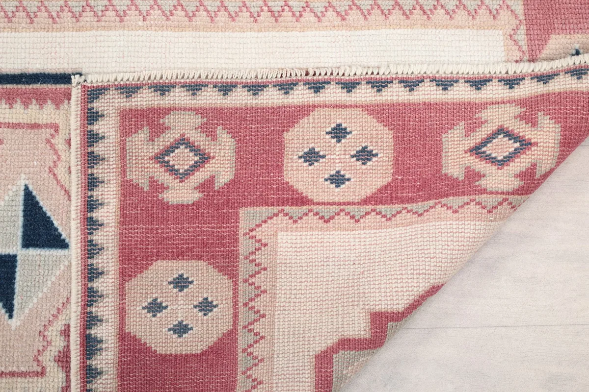 Underside of the rug, showing the hand-knotted construction and the back of the pile.