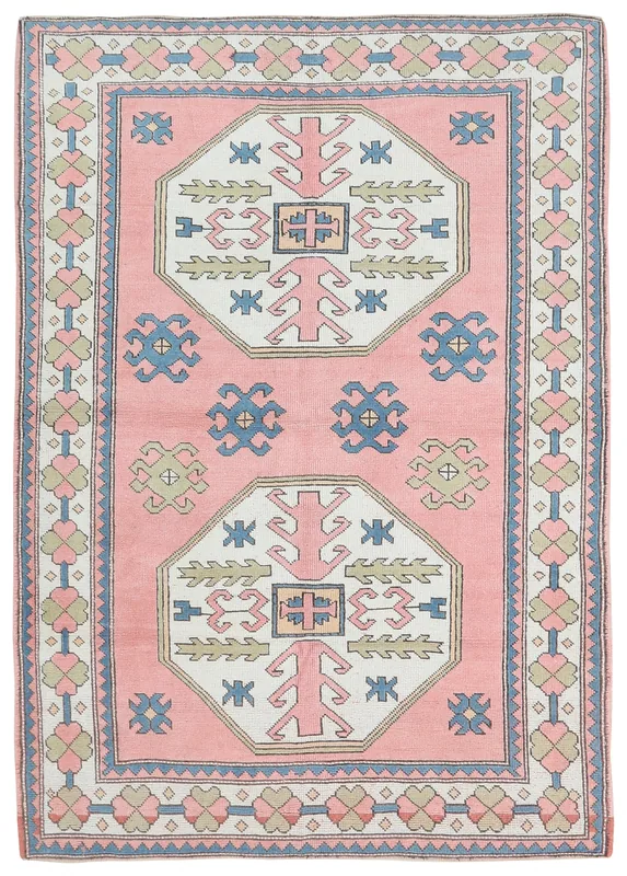 Full overhead view of the rose and ivory geometric Anatolian rug