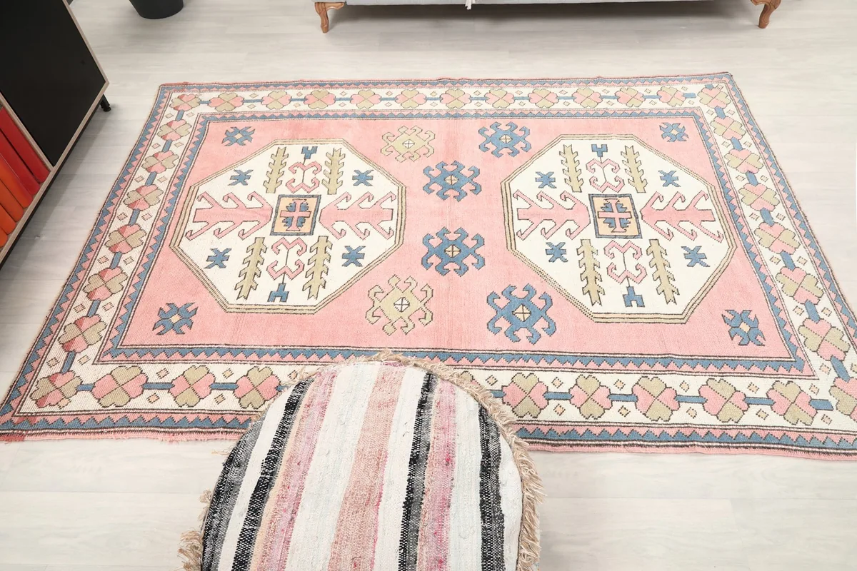 Full overhead view of the rug in a living room, including a striped ottoman