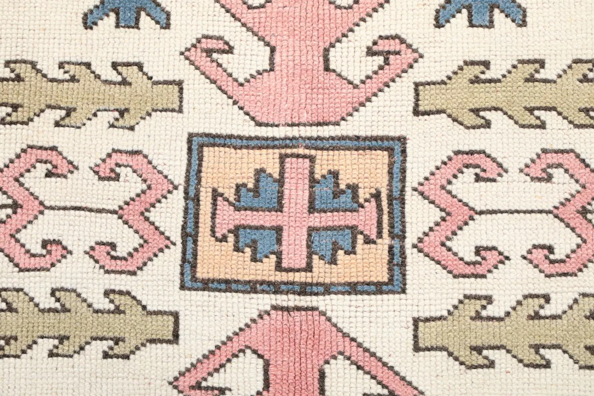 Detailed view of the intricate central motif within one of the ivory medallions