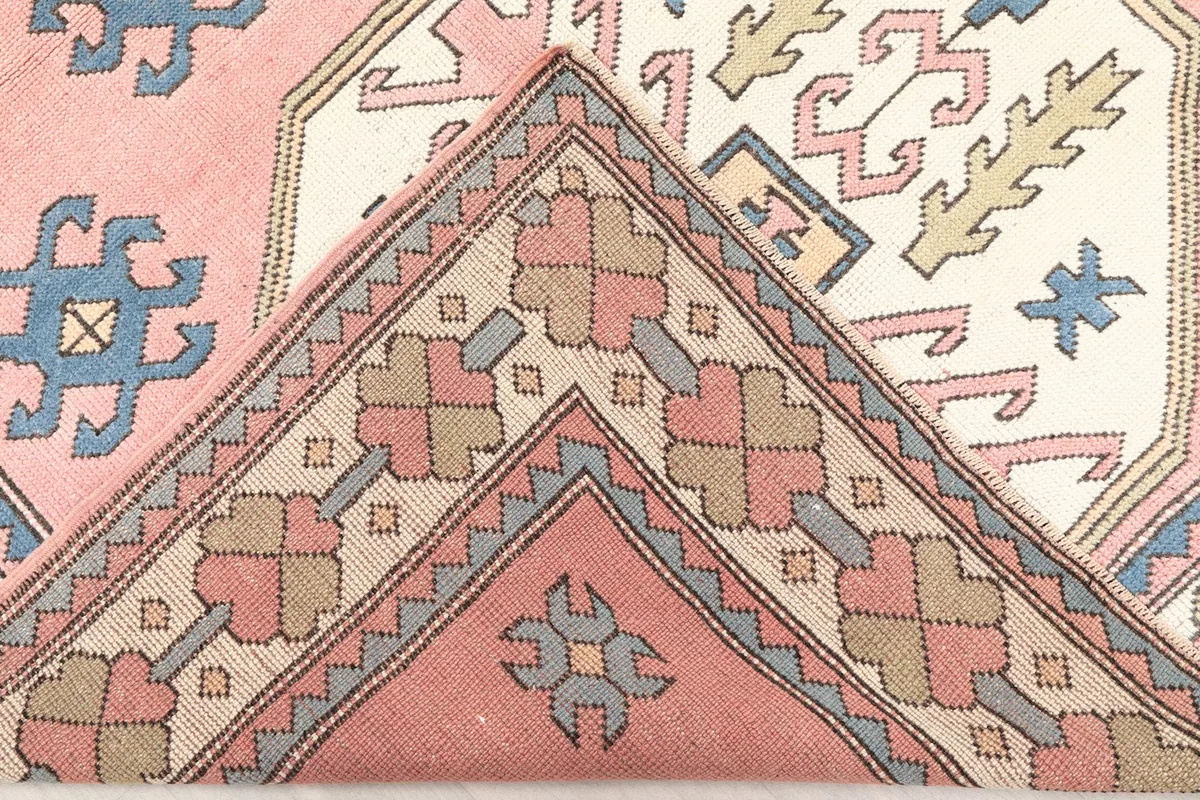 Folded corner of the rug revealing the reverse side of the hand-knotted construction