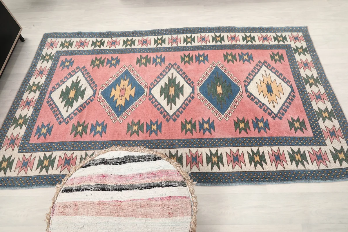 Full overhead view of the vintage rug, emphasizing its rectangular shape and overall design