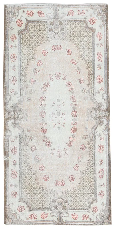 Full overhead view of the 4x7 ivory, rose, and brown vintage Anatolian rug