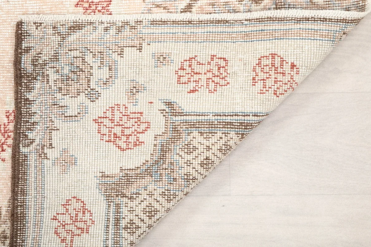 Close-up of the rug's back, showing the knotting and construction details