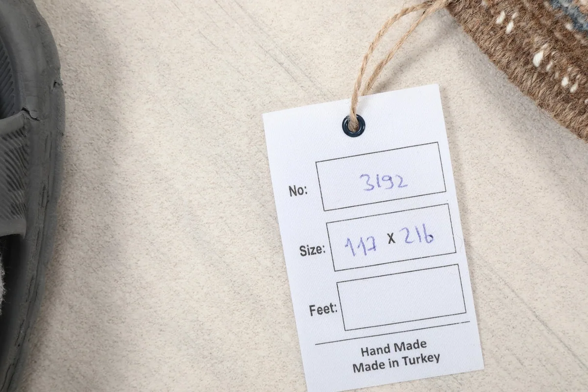 Product tag displaying the rug's dimensions in centimeters and origin as Hand Made in Turkey