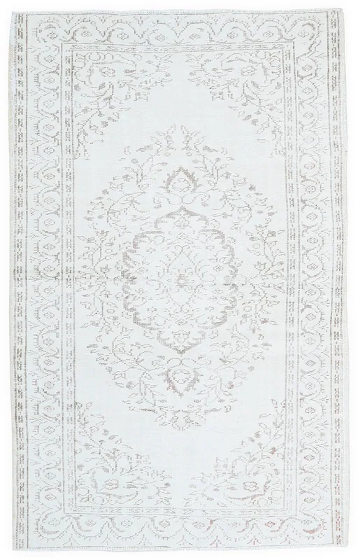 Full top view of the 5'2" x 8'2" ivory vintage Anatolian area rug with a floral medallion pattern.