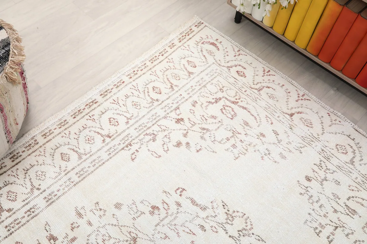 Corner detail of the rug, illustrating the hand-knotted texture and the subtle color variations in the patterns.