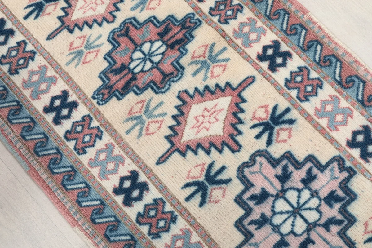 Angled view of the runner rug's central design elements and color variations