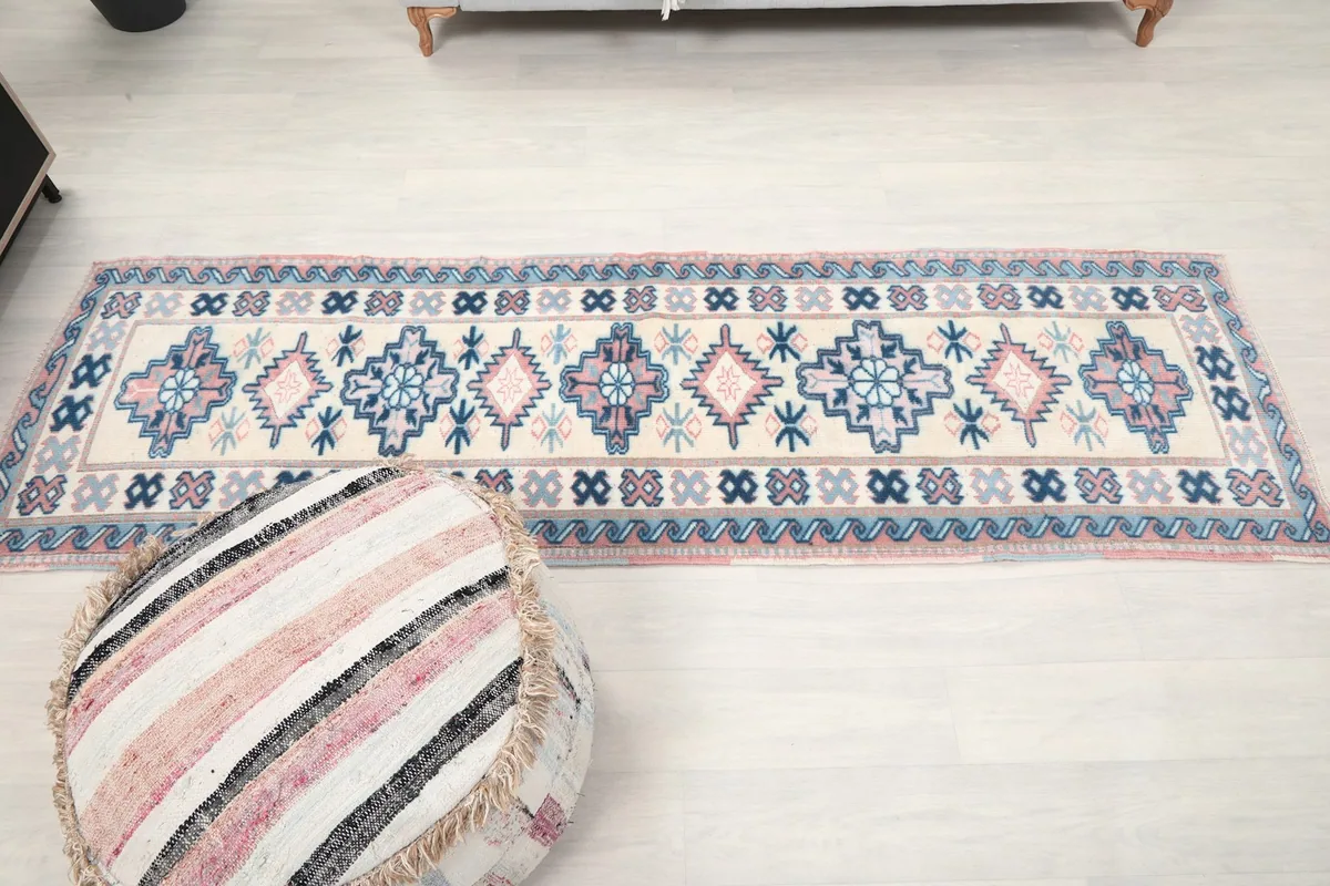 Full overhead view of the runner rug in the room, next to an ottoman