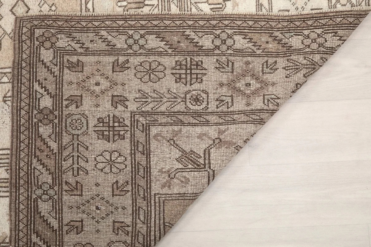 Close-up of the rug's edge and fringe, showing the wool pile and foundation