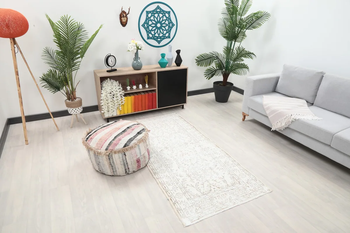 Angle view of the runner rug in a room, showing its placement between a sofa and an ottoman