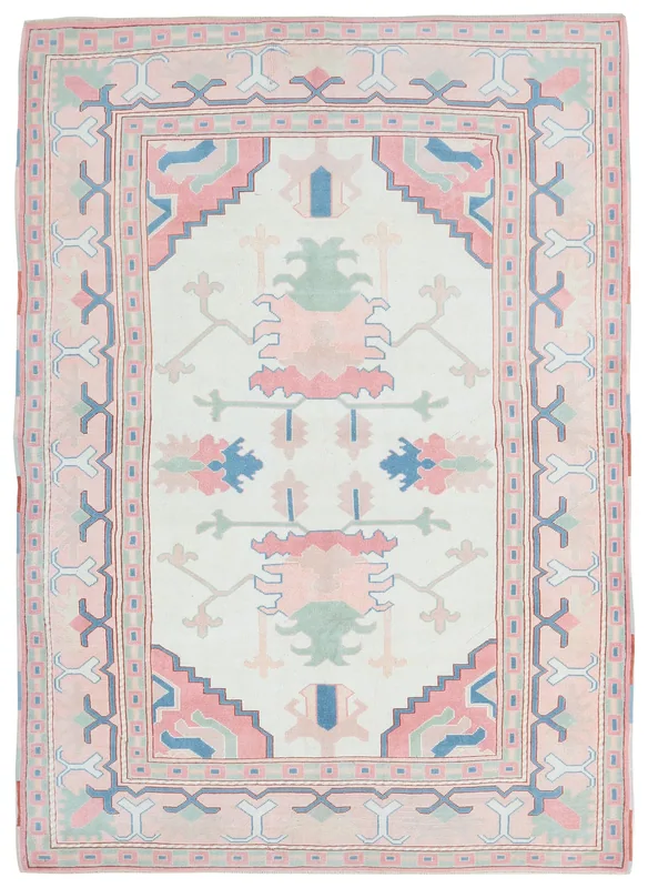 Full top view of the cream, pink, and blue geometric vintage Anatolian rug