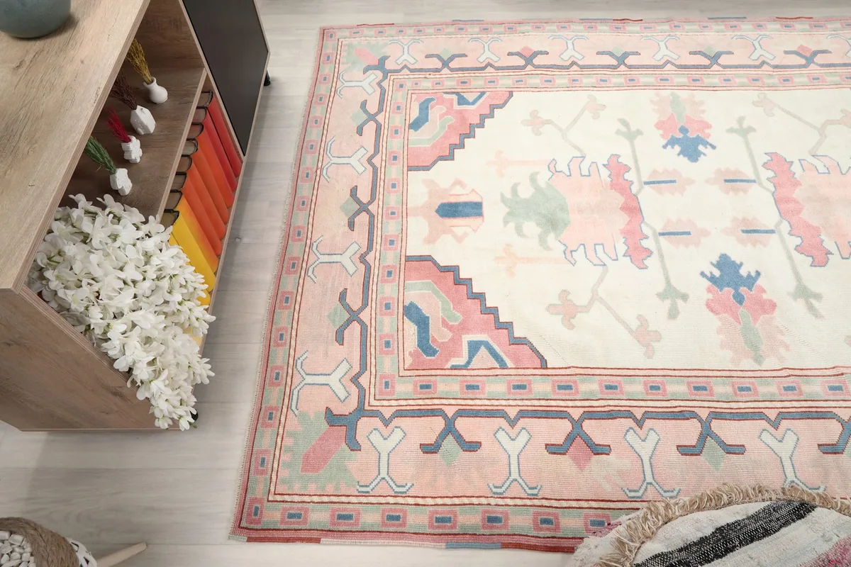 Angled shot of the rug's corner and side in the room, next to a cabinet