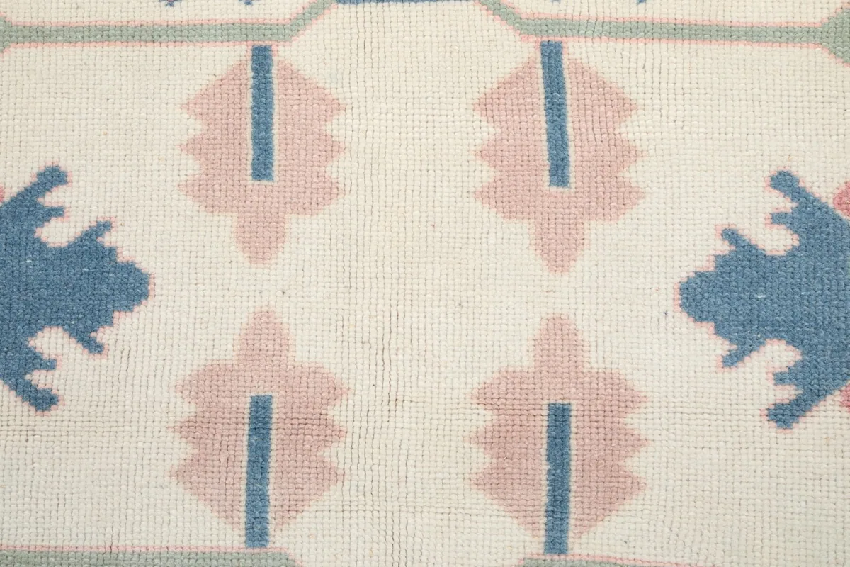 Detailed view of the low wool pile and hand-knotted texture of the rug