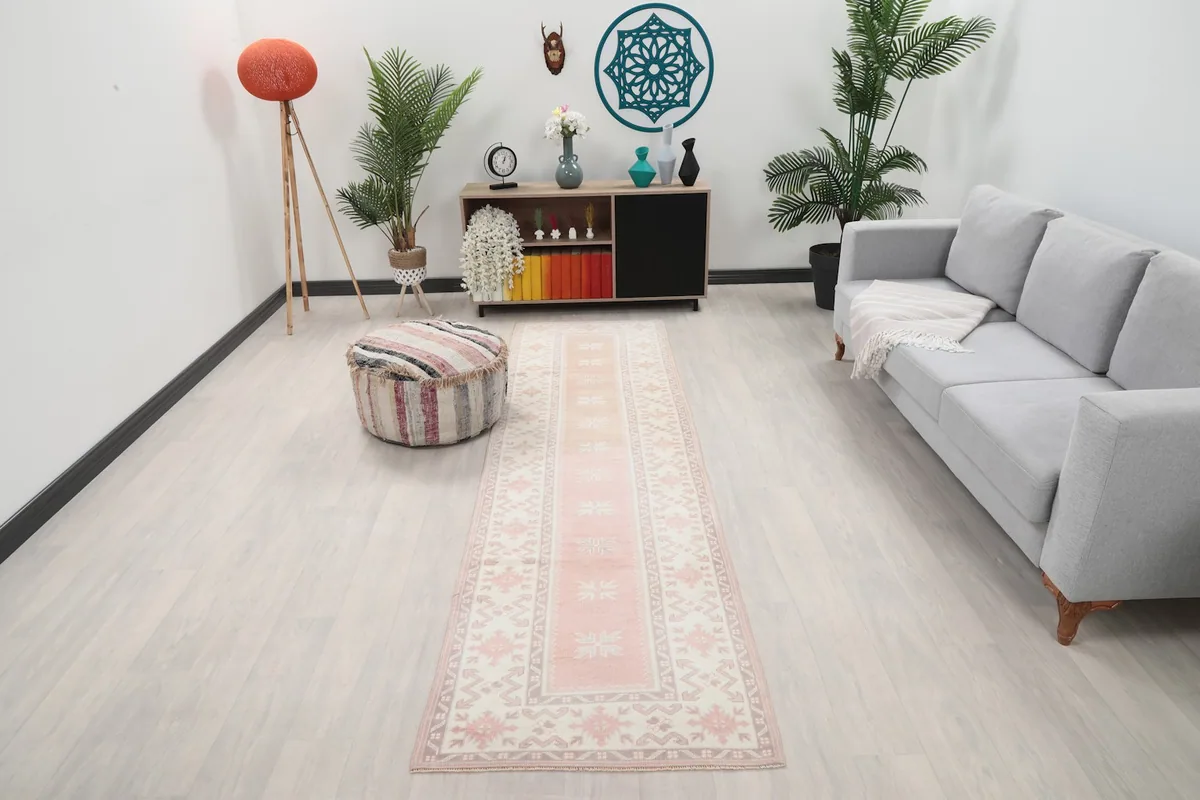 Rose vintage runner rug in a modern living space with light colored furniture
