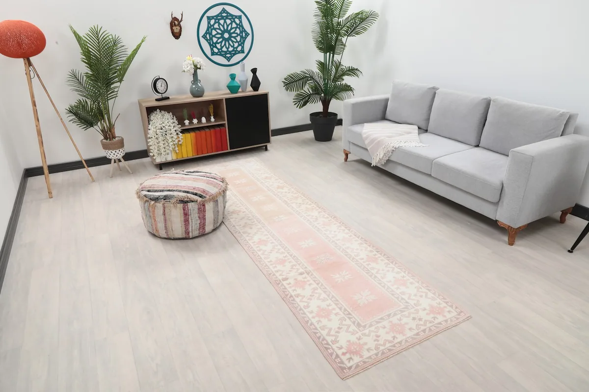 Angle view of the rose runner rug in a room setting, showing its length