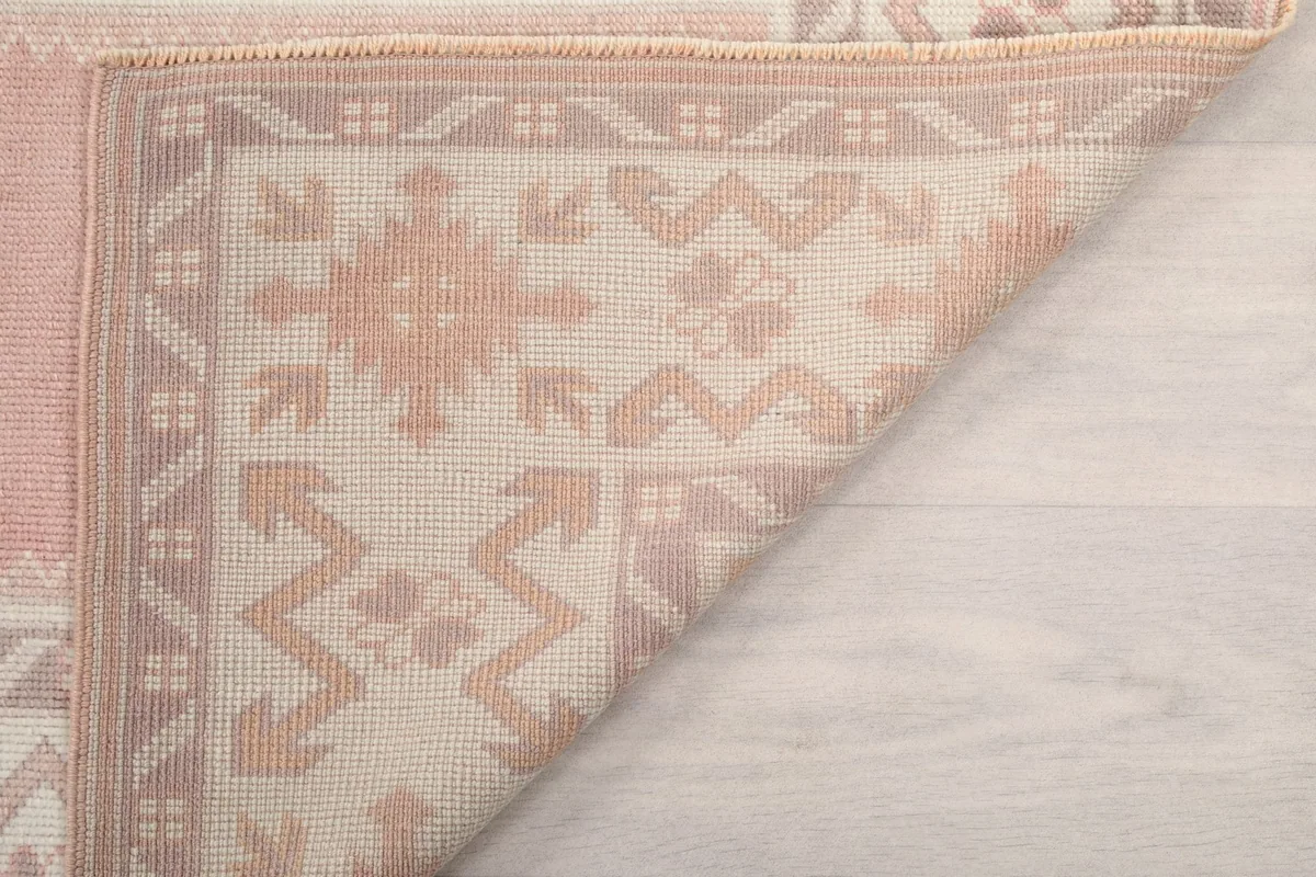 Another view of the rug's reverse side, showing the cotton foundation and knotting