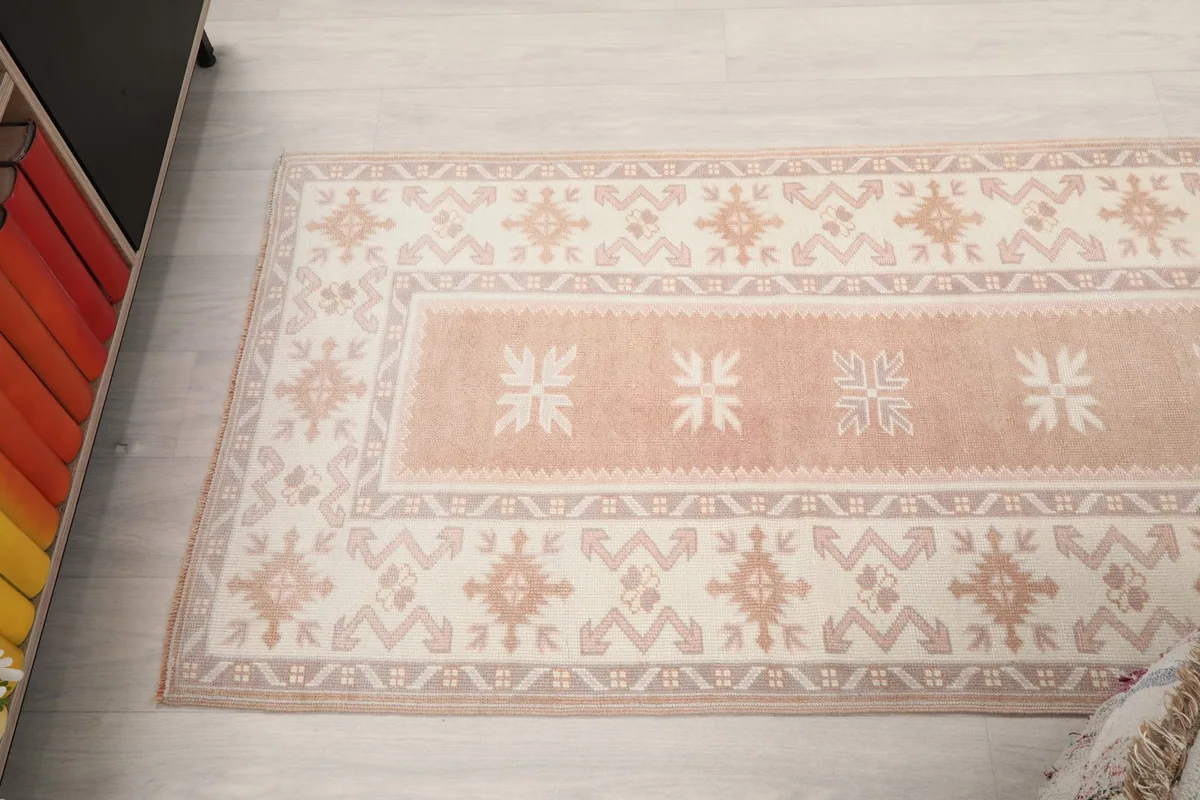 Overhead view of a section of the runner rug, highlighting the central rose field